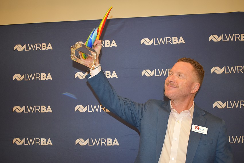 Wayne Parrish of Rite Technology lifts his Bull by the Horns award.
