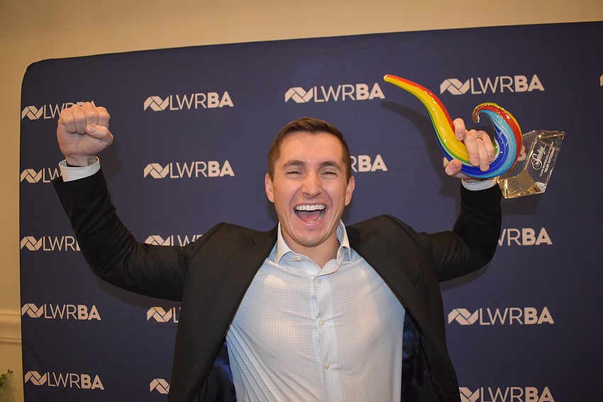 Northern Trust's Tieler Gittleman gives a fist pump after winning the Young Professional of the Year award.