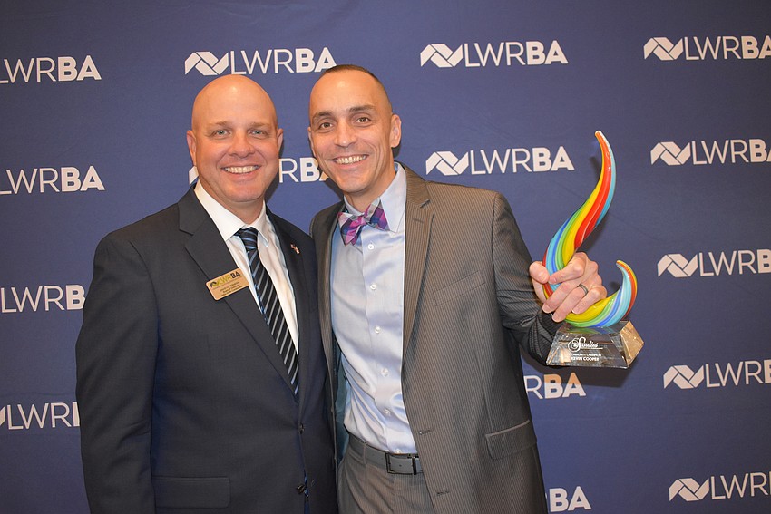 David Otterness of Willis Smith Construction presented the Community Champion award to Mote Marine's Kevin Cooper.