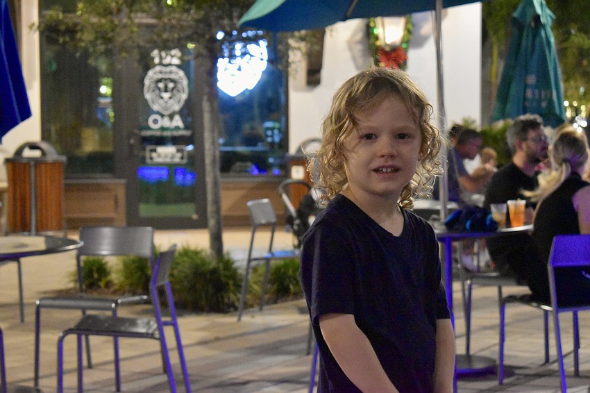 Finley Lanoue explores Waterside Place at night. He's only been to the Farmers' Market during the day.