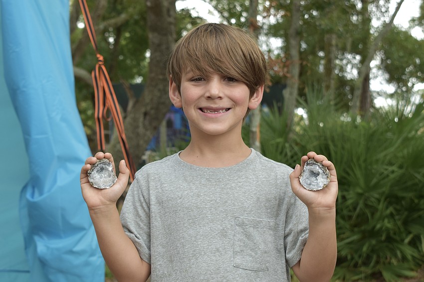 Ryker Fox, 7, holds the broken geode.