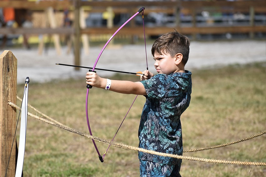 Maksim Knipp, 6, takes aim at a target.