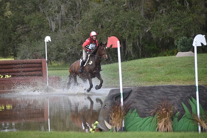 New Zealand's Joe Meyer and Chilli Dawn slosh through the water on the cross country course during The Event at TerraNova.