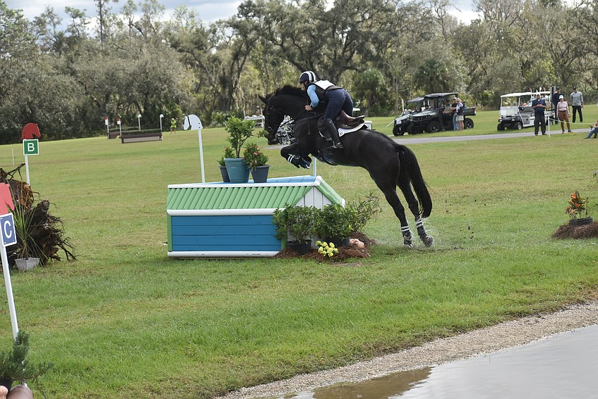 Georgia's Sallie Johnson and Ado Rock launch into the air to easily clear a jump on the cross country course during The Event at TerraNova.