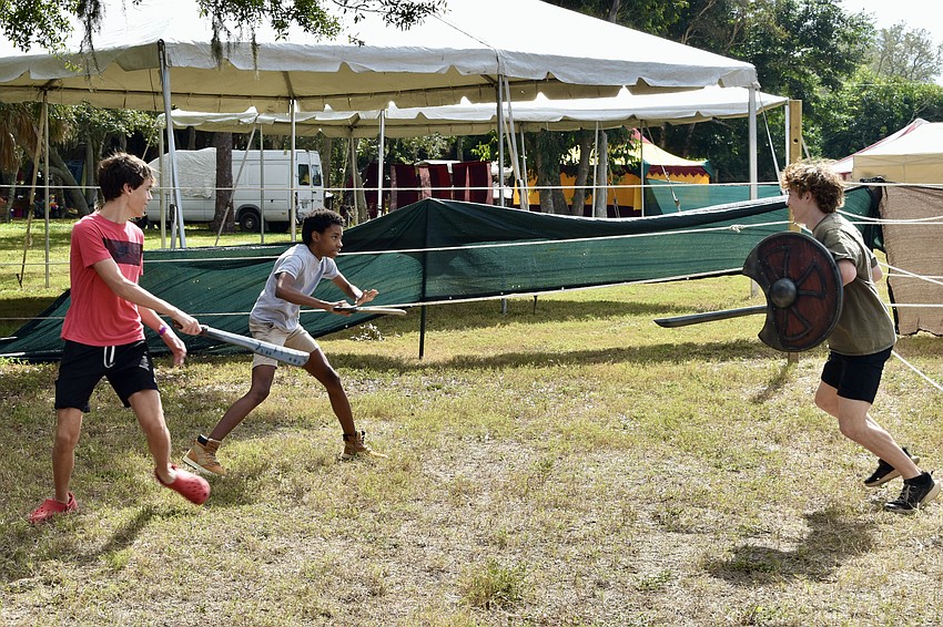 Roscoe Long, 14, Owen Meredith, 15 and Ezra Weinstein, 14, face off against each other at the Sword Master's Challenge arena.