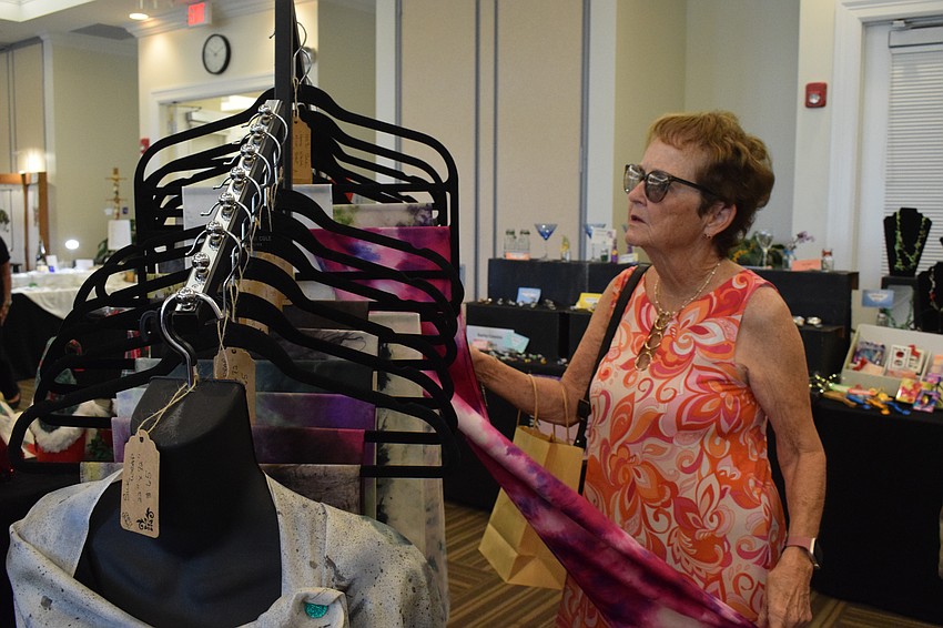 Esplanade's Trice Ranellone looks at the selection of scarves.