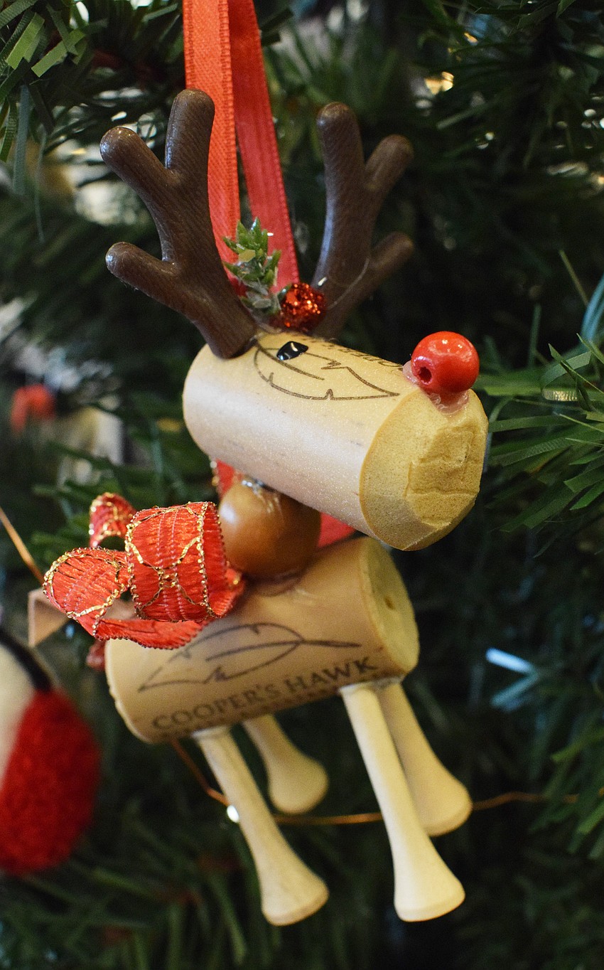 Polo Run's Linda McMillan uses wine corks from Cooper's Hawk in Sarasota and golf tees to create her reindeer ornaments.