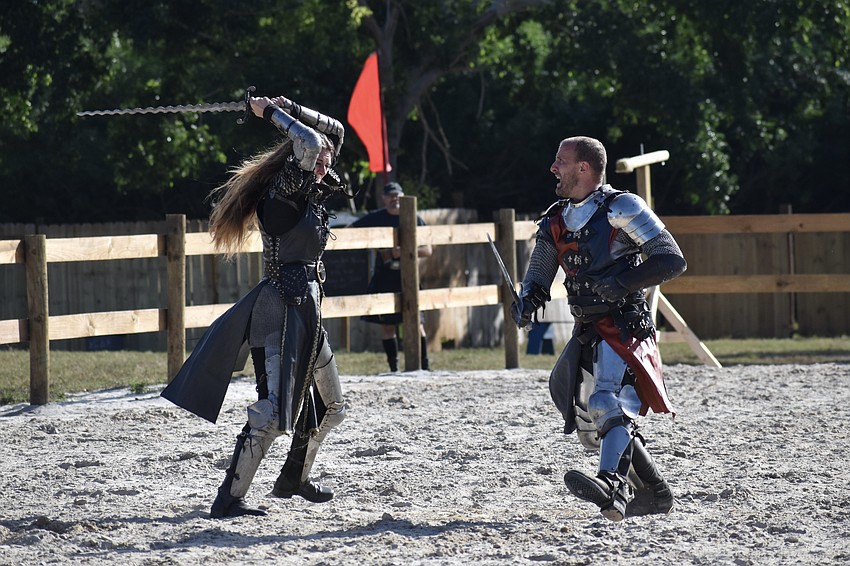 Sir Lilith (Erin Eisenmann) and Sir Michael (Michael Murphy) face off against one another in a sword fight.
