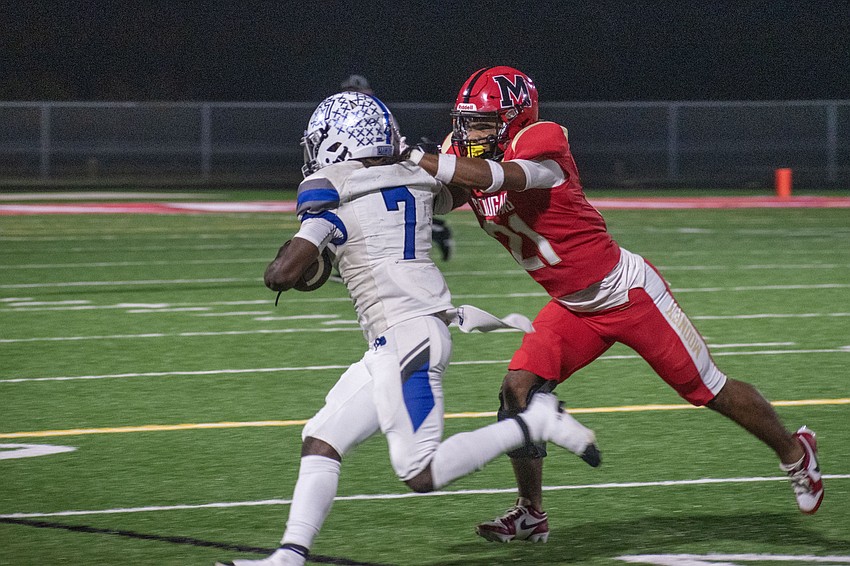 Cardinal Mooney senior Zeshon Casimir makes a tackle on Lakeland Christian's Josh Bellamy Jr.