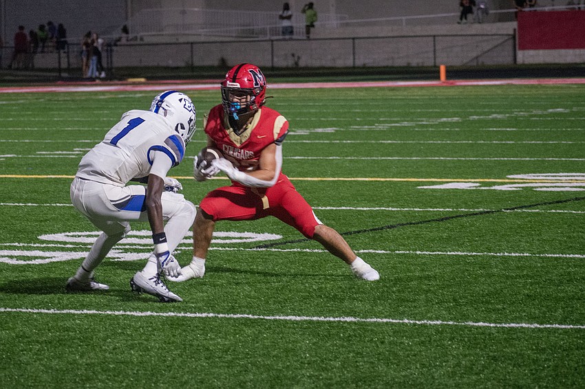 Cardinal Mooney senior Carson Beach jukes out Lakeland Christian junior Ian Goines.