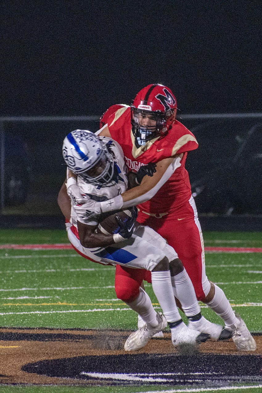 Cardinal Mooney sophomore Bryce Fulda swallows up a Lakeland Christian rusher for a loss.