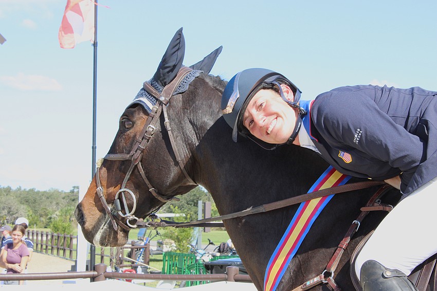 Jenny Caras of Cartersville, Georgia, gives her horse Trendy Fernhill a hug after winning The Event at TerraNova Nov. 19 in Myakka City.