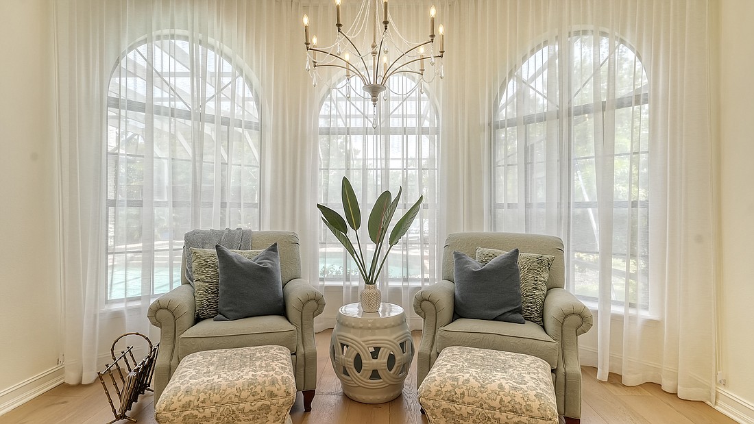 A raised seating area in the primary suite offers a quiet nook for reading and relaxation.