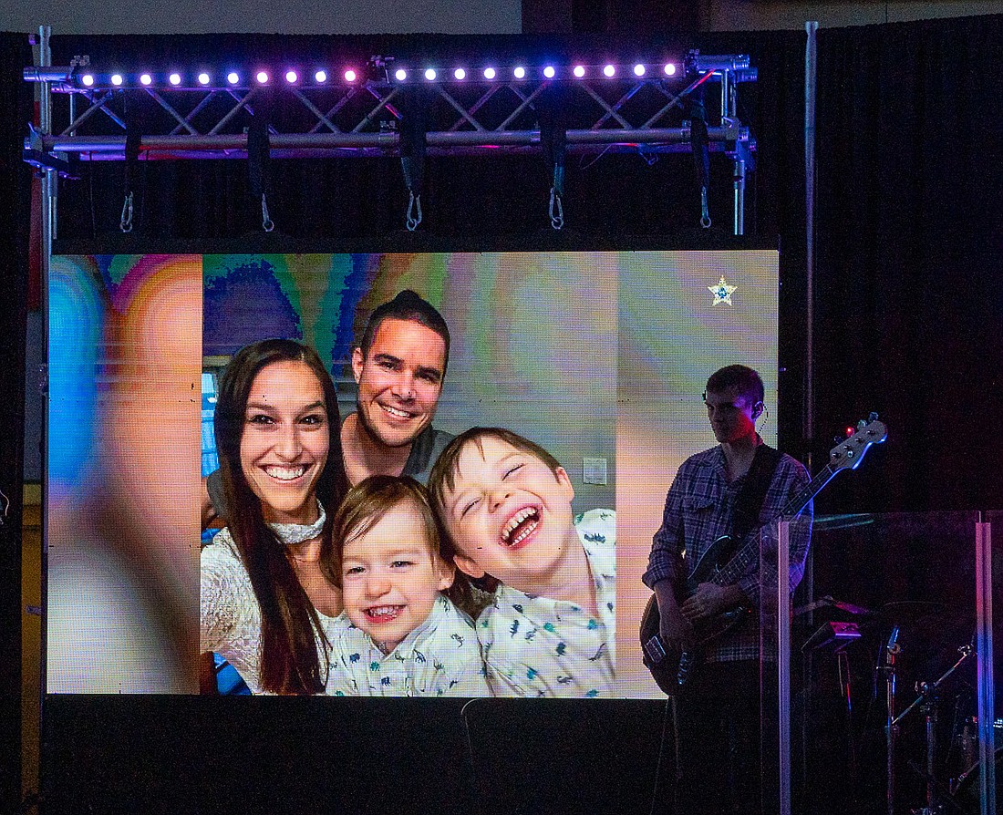 A photo of Mike Milmerstadt and his family was shown on the big screen during the Hero Day program.