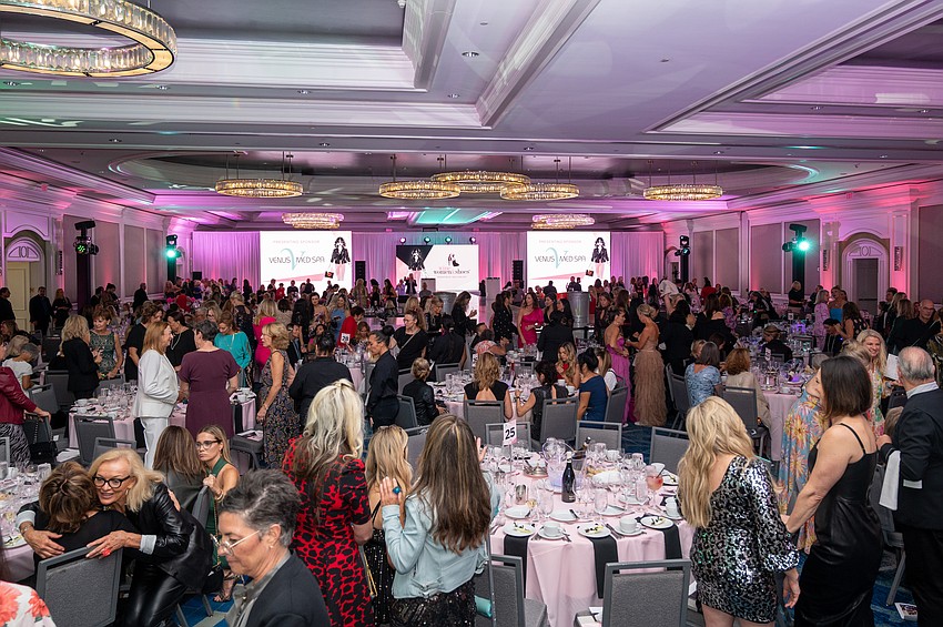 Guests find their seats for the fashion show.