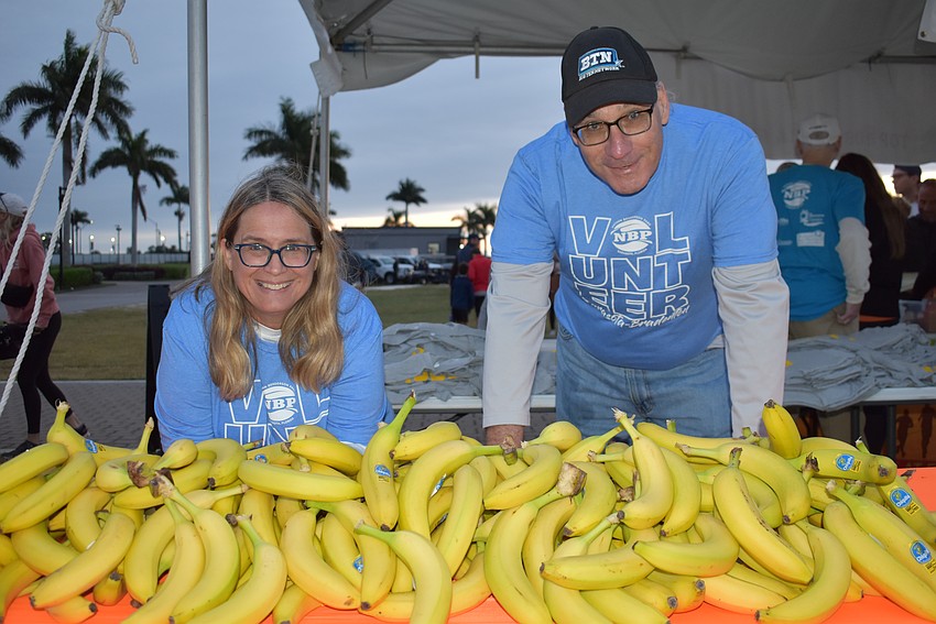 Nathan Benderson Park volunteers Kelly Paulina of Tampa and Robert Larson of East County hand out bananas to the runners at the Florida Turkey Trot.