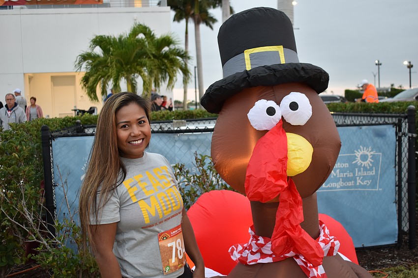 Sarasota's Alona Prine has a little fun before the start of the 5K on Thanksgiving morning.