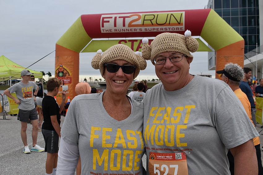 Sarasota's Courtney Rayne and Cindy Weiss wear knitted turkey hats made by Rayne's aunt, Cathy Williams.