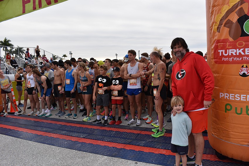 Parks Robinson and his son Blaise (farm right), get ready for the start of the Florida Turkey Trot at Nathan Benderson Park. Robinson's Fit2Run has run the race all six of its years.