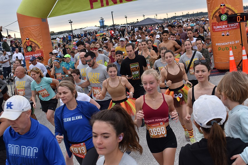Runners pour out at the start of the sixth annual Florida Turkey Trot at Nathan Benderson Park on Thanksgiving morning.
