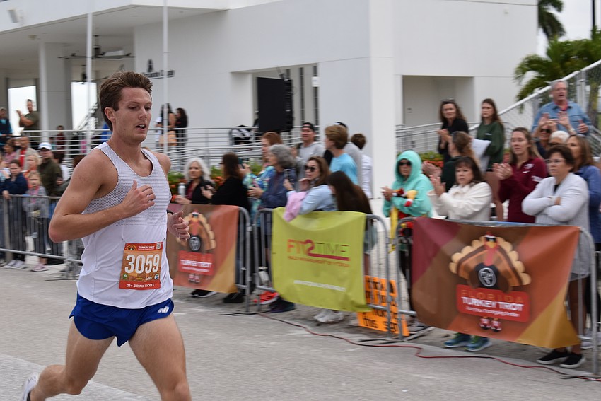 Colin Waters, a former Penn State cross country runner, cruises past the finish line to win the Florida Turkey Trot in 14:57 on Thanksgiving morning at Nathan Benderson Park in Sarasota.