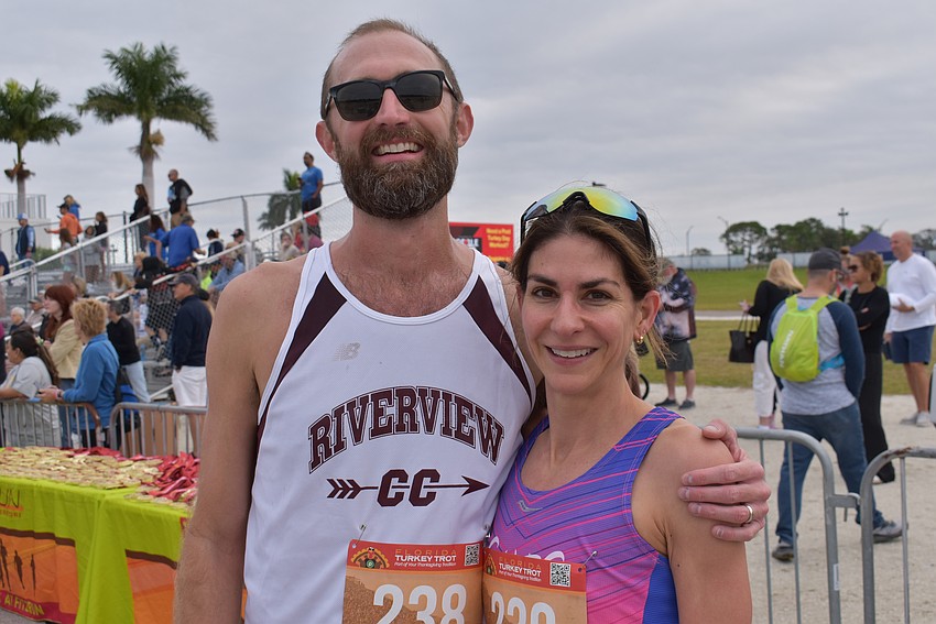 Tallahassee's Zach DeVeau, a former Riverview High runner, poses with his wife, Katie Sherron, after she won the women's division of the Florida Turkey Trot. 