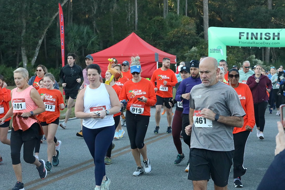 A wave of runners at the start of the Feet to Feast 5K. Photo by Brent Woronoff