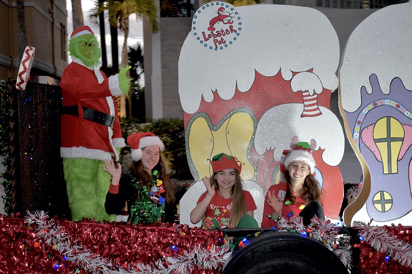 Tony Medeiros (as The Grinch); Vivian Grey, 14; Mikayla Medeiros, 13; and Katelynn Lorber, 17, of Lobster Pot ride by in a float.