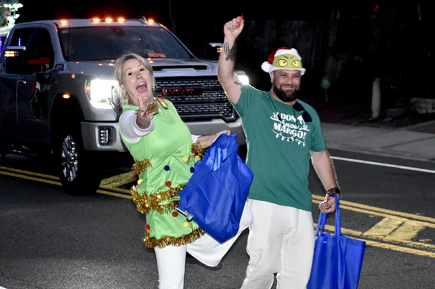 Cheryl Eason and Paul Fredell, of the Parasail Siesta and Air Force One float, toss candy