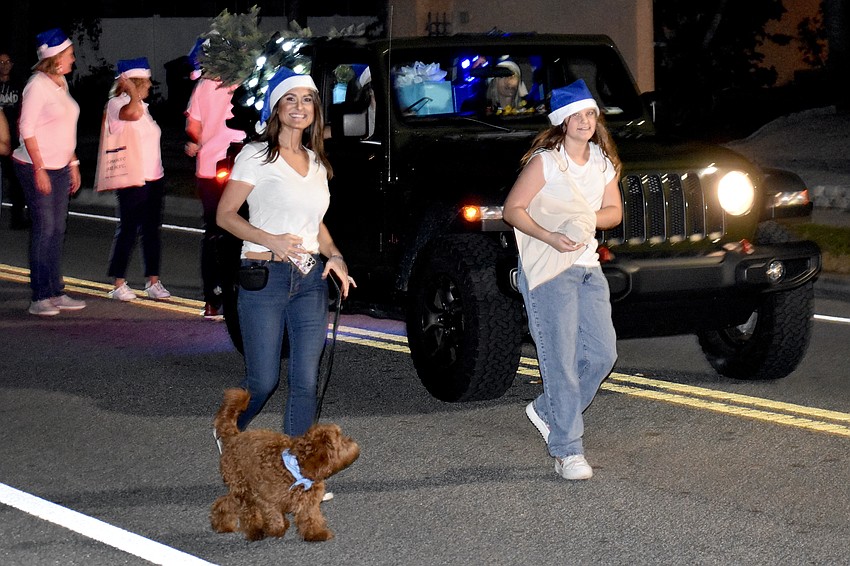 Naiya Marisol-Pote and Charlotte Pote, 10, walk in the parade with Michael Saunders & Company.