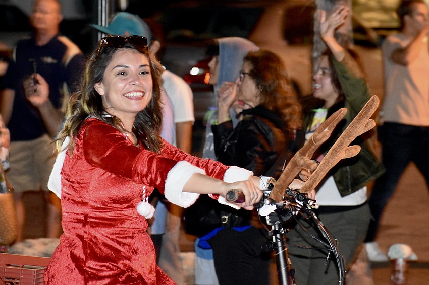 Amber Guerra rides a bicycle in the parade.