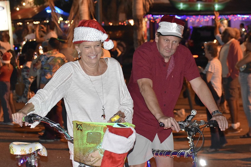 Dee DeSpirlet and Barry Cline make their way through Siesta Key Village. Each year, they participate in support of Key Life Charters, which hosts Santa Claus.
