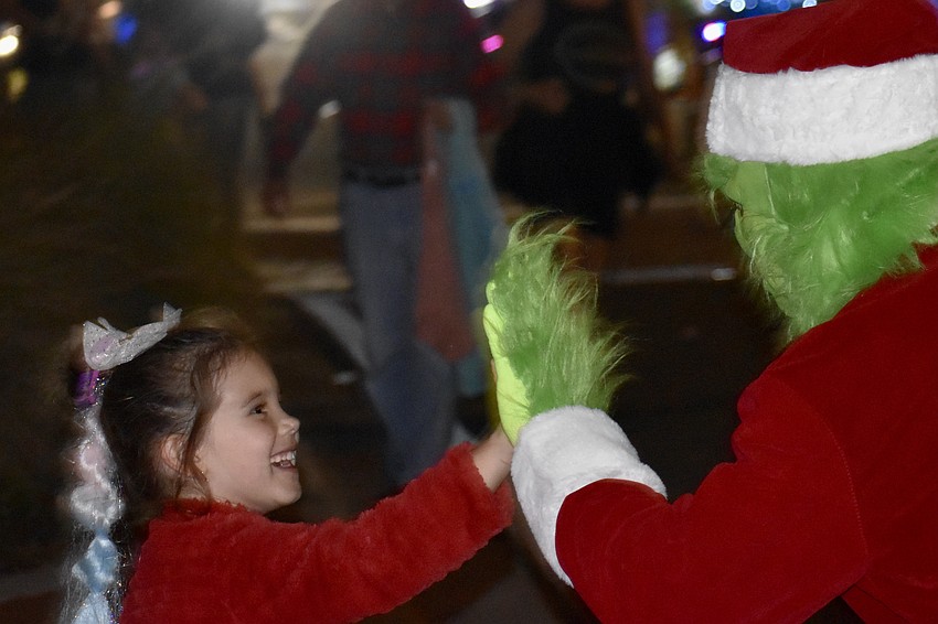 Emily Hahn, 6, meets The Grinch (Mark Cote), while in Siesta Key Village.