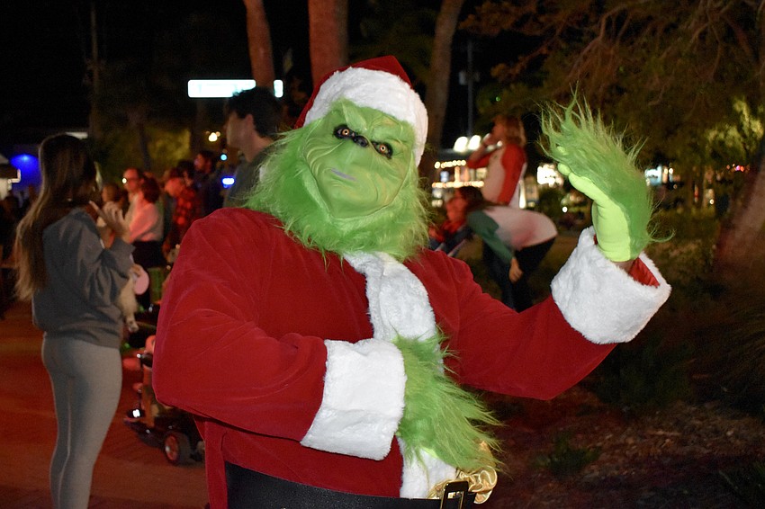 Mark Cote walked through Siesta Key Village dressed as The Grinch.