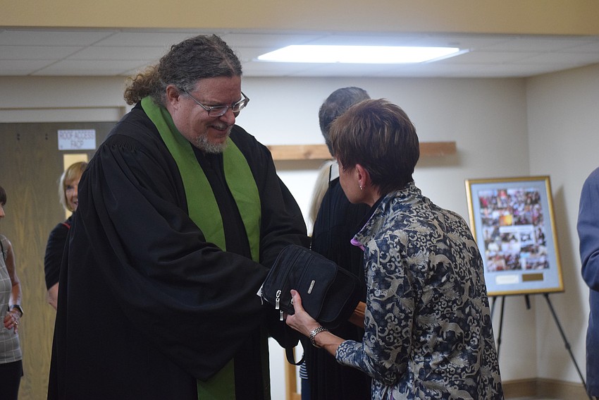 Rev. Jeffrey Nunes greeting peoople after the service