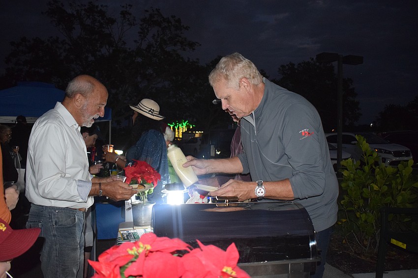 Chris Sachs serving food at the Kiwanis Club table