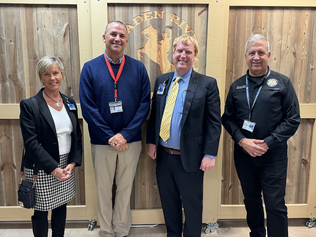 Annette Codelia, executive director of elementary education; Braden River Elementary School Principal Joshua Bennett; Superintendent Jason Wysong; and School Board of Manatee County member Richard Tatum celebrate Bennett being named the district's Principal of the Year.