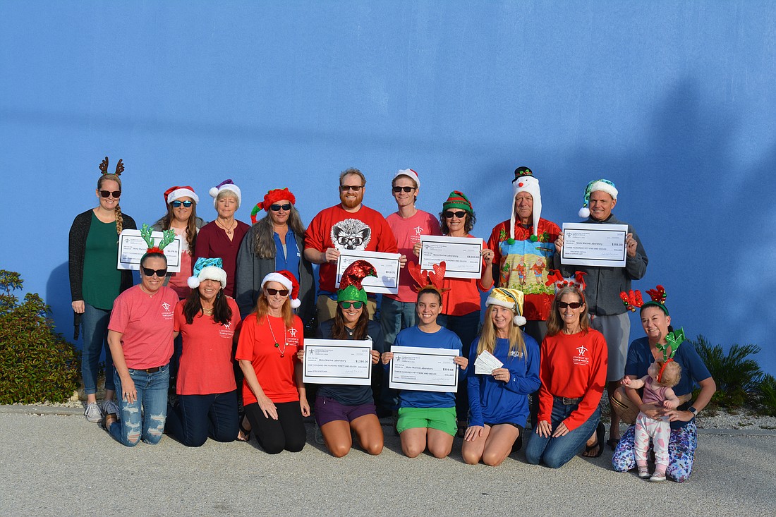 Longboat Key Turtle Watch volunteers presented checks to Mote Marine Laboratory & Aquarium on Dec. 1.