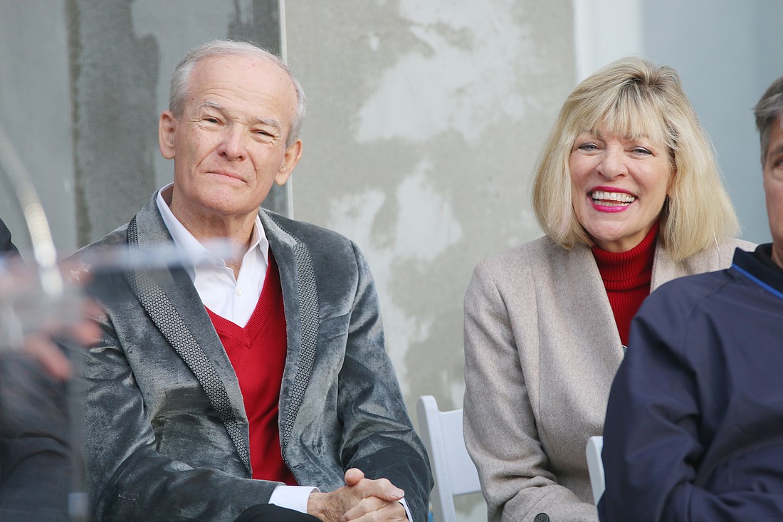 Lowell and Nancy Lohman listen to Mayor Bill Partington speak during the topping off ceremony for The Cupola at Oceanside on Thursday, Nov. 30. Photo by Jarleene Almenas