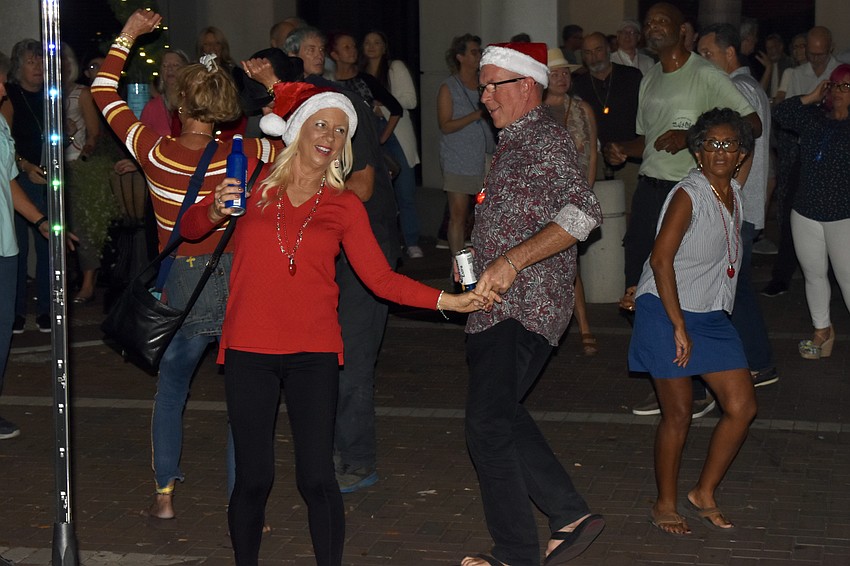 Connie Schedit and Joe Janusz get into the festive spirit with dancing.