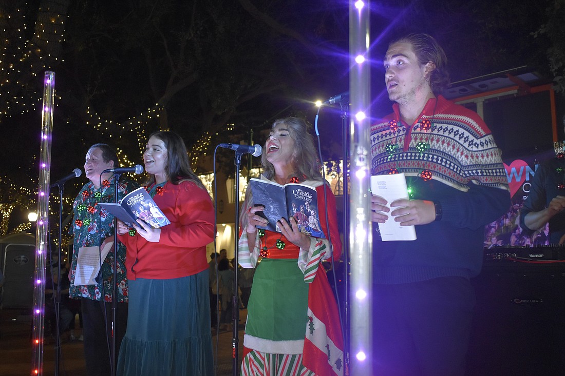 James Madden, Julia Mergen, Culver Casson and Steffen Robinson of The Christmas Carolers offer a performance.
