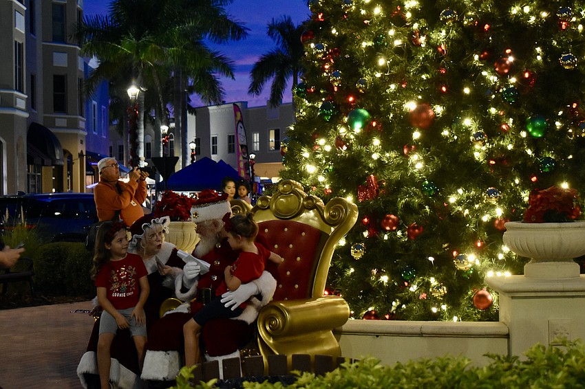 Santa and Mrs. Clause stay throughout the evening for photos in front of the Christmas tree.