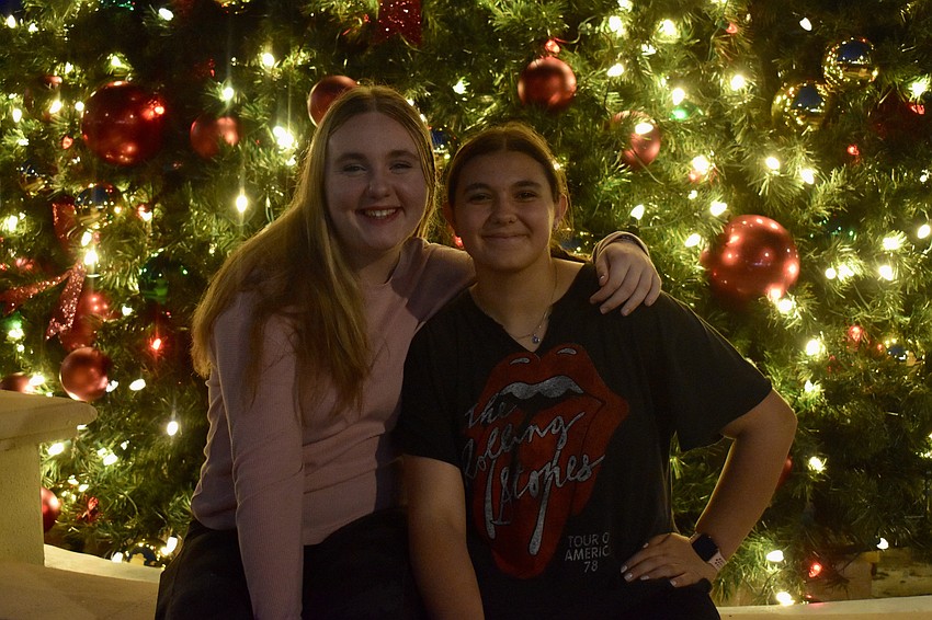 Sophia Emmons and Jersey Baldini stop for a picture in front of the tree. This is Emmons third year watching the tree light up on Lakewood Ranch Main Street.