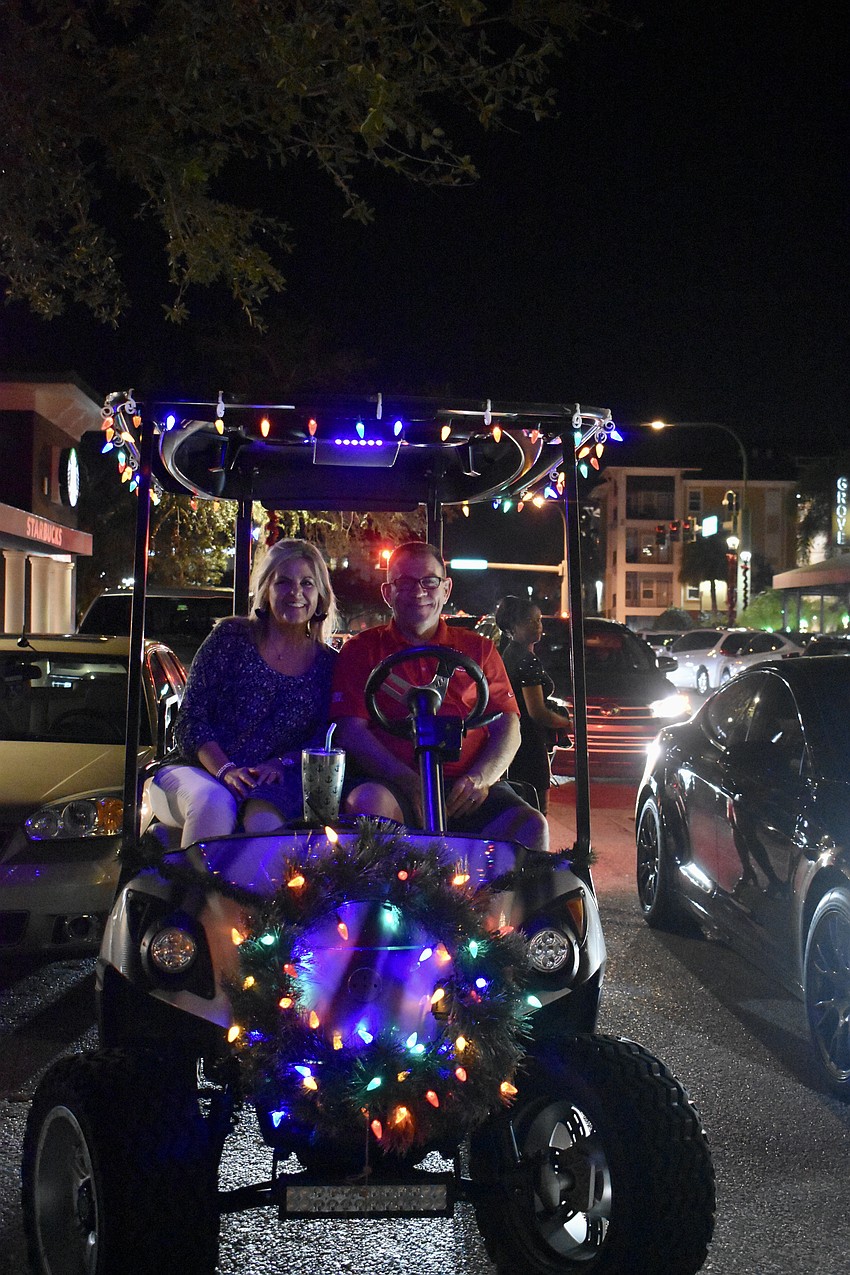 Dwayne and Brandy Britton pull up on Dwayne's new golf cart.