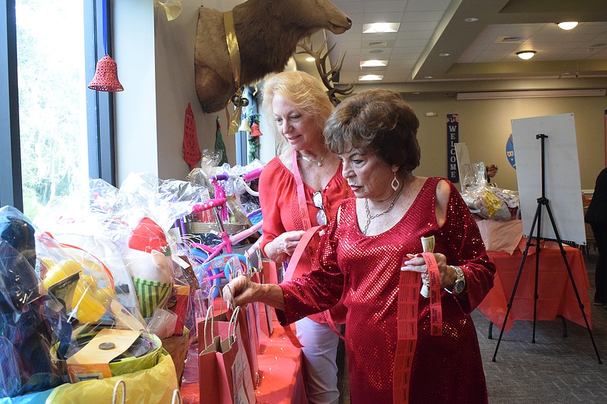 Lakewood Ranch's Gale Martin and Joyce Brown look at the available raffle items at the Lakewood Ranch Elks Lodge.