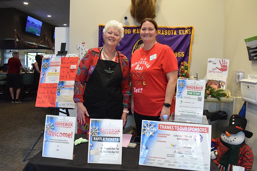 Sarasota's Marie Gowgiel, a volunteer for Meals on Wheels Plus of Manatee, and Dana Maassen, the nonprofit's chief financial officer, greet guests and collect donated shoeboxes.