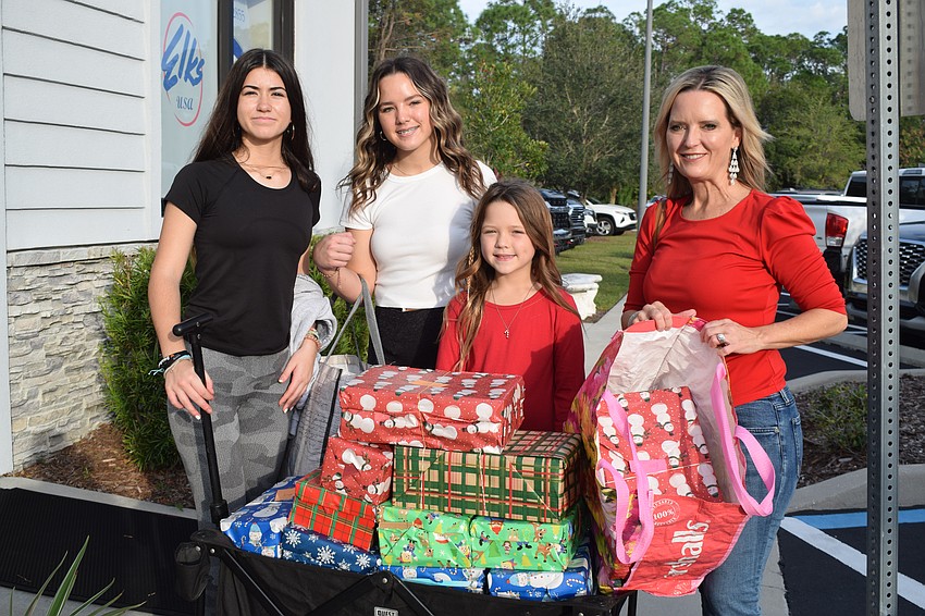 East County's Sam Gibson and Campbell Pope, who play for Gulf Coast Volleyball, donate shoeboxes they made with their teammates Layton Pope and Summer Smith-Pope. The 11 girls on the team donated 21 boxes.