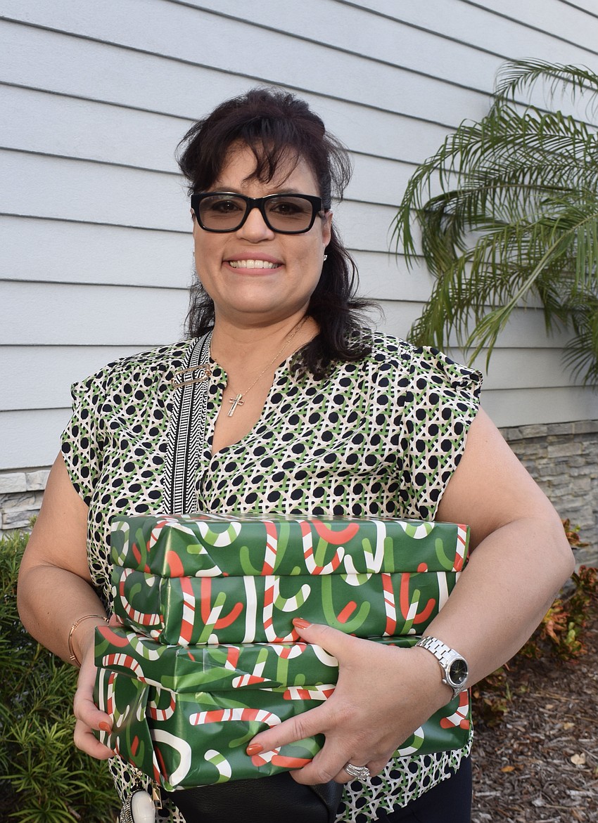 Lakewood Ranch Barbara Milian brings two shoeboxes and a $500 donation.