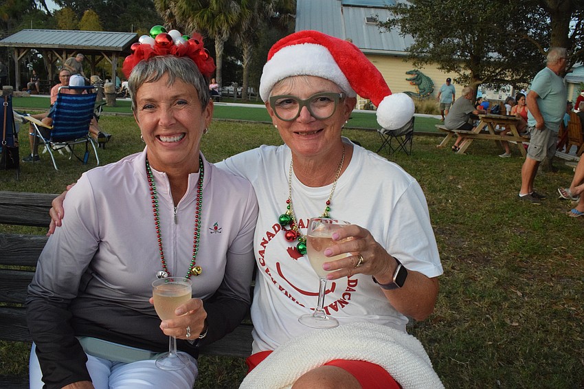 Tara's Sheila Buck and Wendy Benson add to the holiday spirit at the Holiday Boat Parade at Jiggs Landing with their festive outfits.