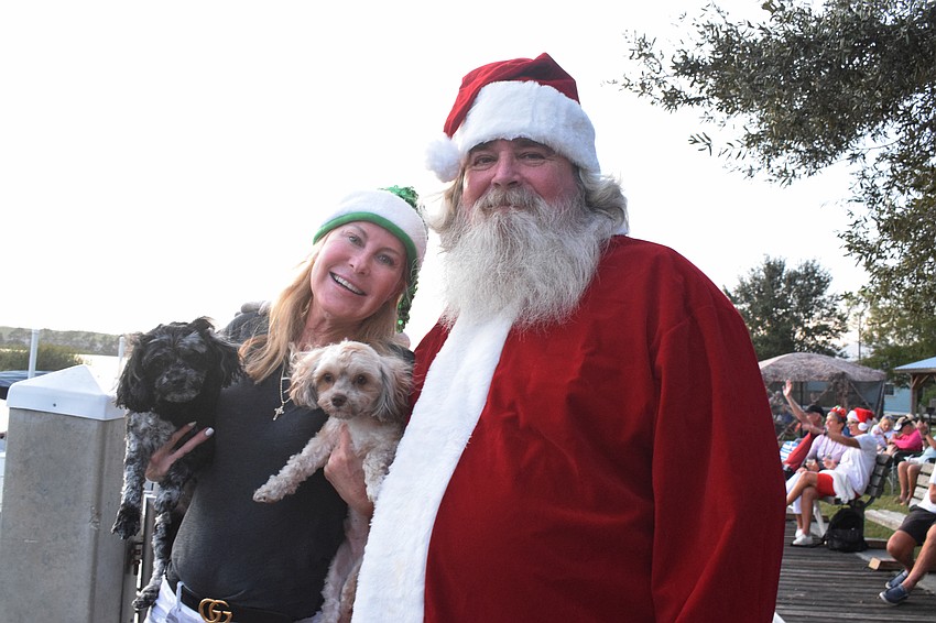 Anna Maria Island's Jill Diesman and her dogs get a visit from East County's Greg Sheppard, or Santa.